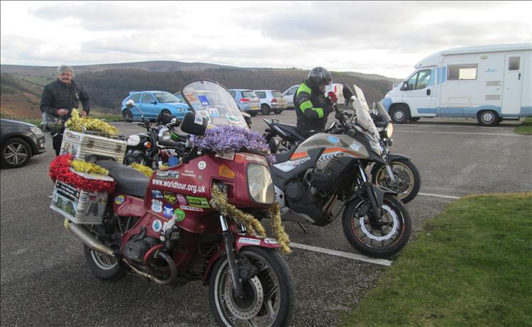 A BMW R800 with luggage and covered in Christmas tinsel