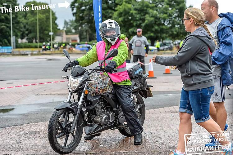 Sharon on the colourful Keeway in her rain gear at the All Female Biker Meet