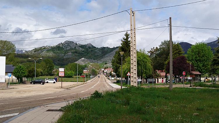 In a small Spanish town the straight road heads out into the white rocky hills in the distance