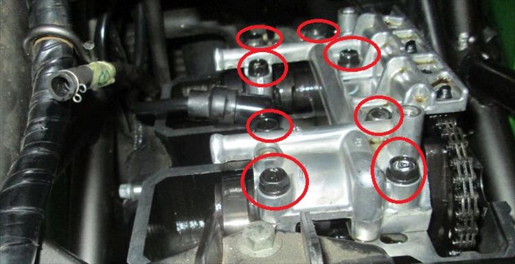 The casting covers the valves and is held on with 8 bolts circled in red