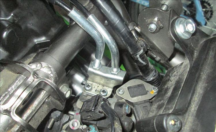 The 2 throttle cables leading to the throttle body under the tank