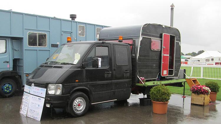 A normal flatbed truck with a small caravan body fixed to the back