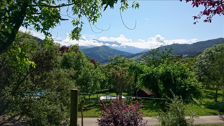The snow tipped and lush green mountains of the Picos and Potes from the campsite