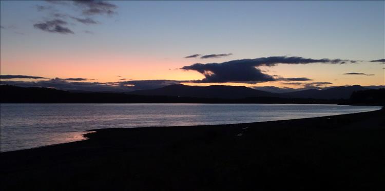Calm loch waters, darkening skies, light cloud as the day ends at Benderloch