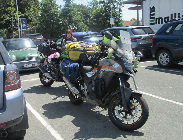 Sharon and the heavily loaded bikes at a supermarket car park in Welshpool