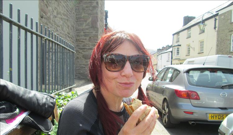 Sharon stuff her face with a butty looking cool in shades at Crickhowell