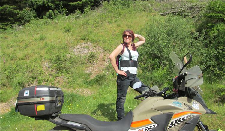 Sharon poses like a supermodel in her bike pants, vest, sunglasses and boots