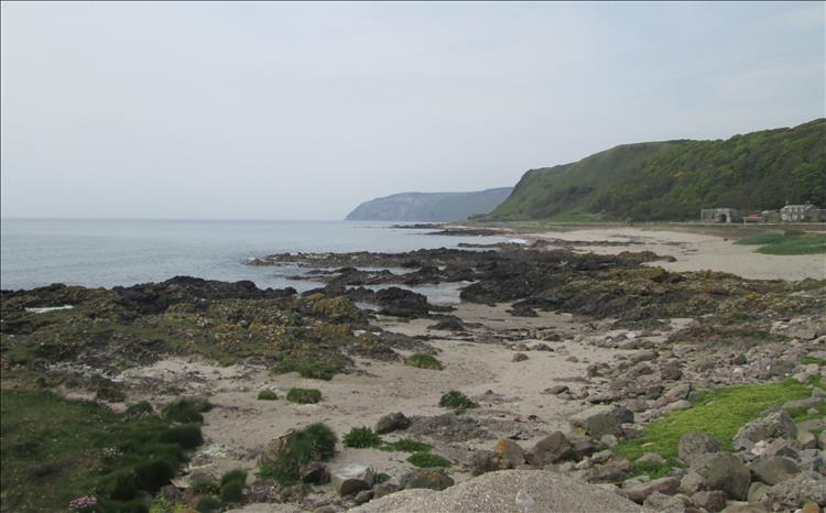 hard angular rocky outcrops mixed with sand and the sea at Southend Mull of Kintyre