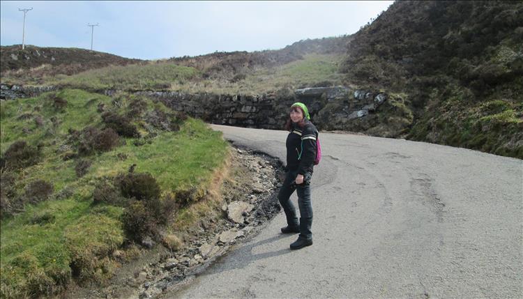 Sharon stands on a sharp steep bend on the treacherous road to the lighthouse