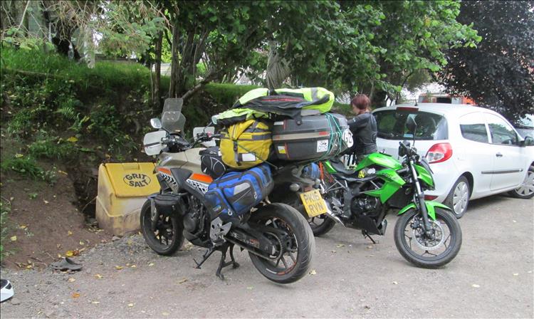 Both the CB500X and Z250SL are buried in a mound of luggage