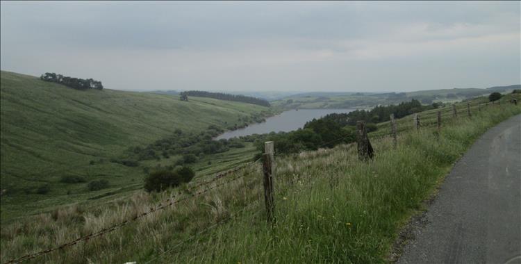 A reservoir and valley in the rolling countryside of the brecon beacons
