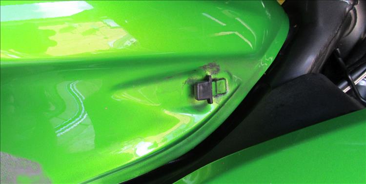 A new rubber cover over the tongue on the tank that secures the side panel