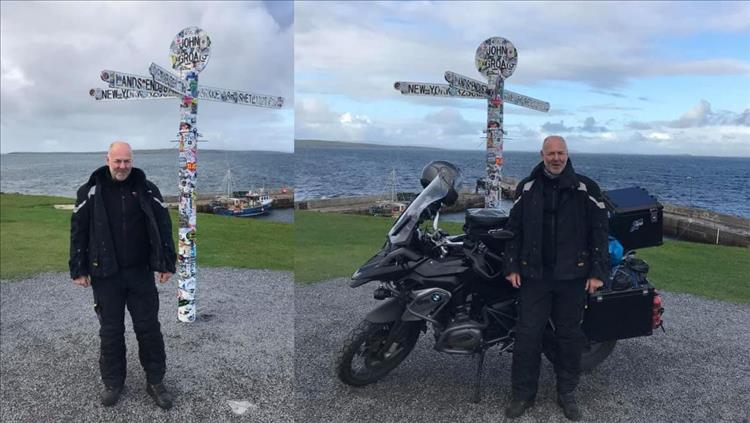 Andy with the bike, andy without the bike at the signpost of John-O-Groats