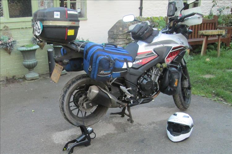 Ren's CB500X with luggage and a footpump connected to the rear wheel