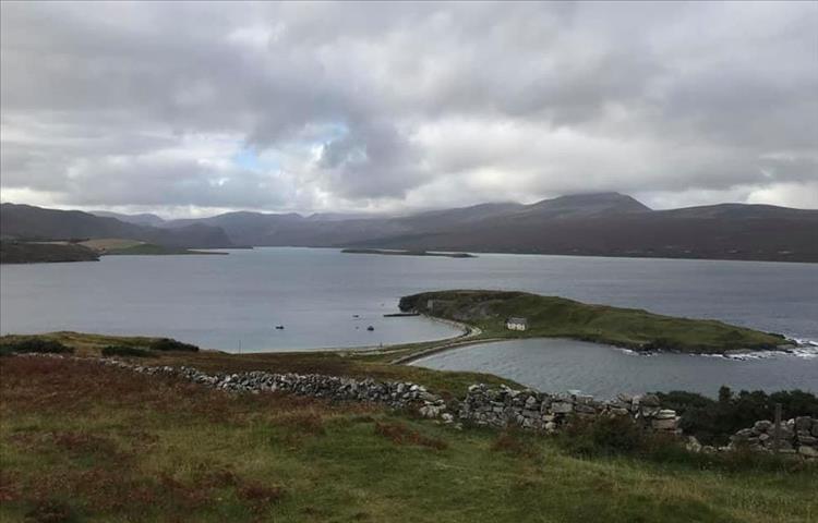 Loch Eriboll with grassy outlets, rolling hills and heavy skies