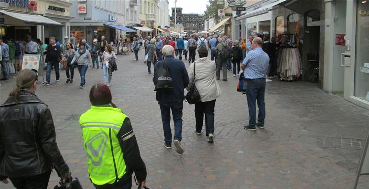 We see Sharon and Laura's backs as they walk and talk around the shops in Trier