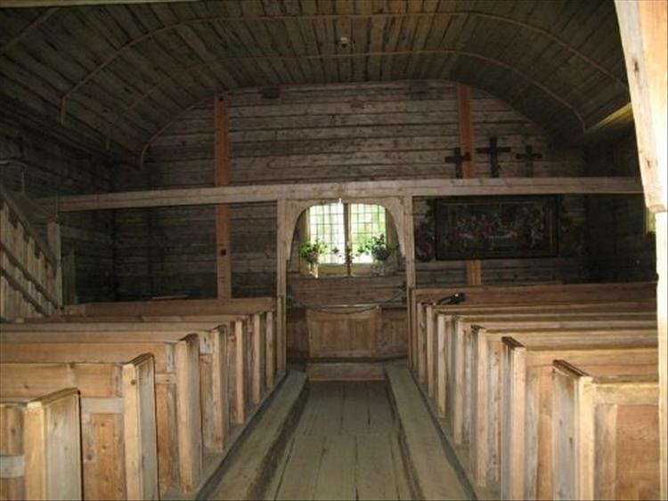 A small all wooden church, very simple and tightly packed with pews