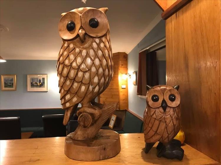 2 carved wooden owls at the Bay Owl Inn