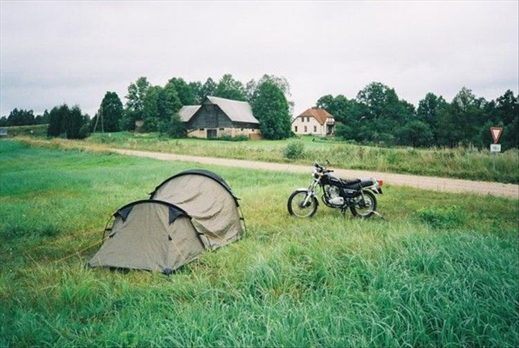 The tent and the Suzuki GN125 in a regular farmer's field in the Eastern European countryside