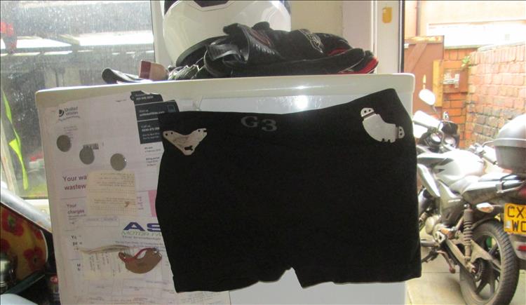 A pair of underpants stuck on a regular old fridge
