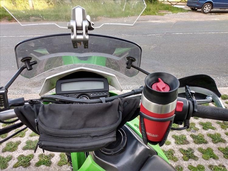A bumbag or fanny pack strapped around the handlebars of Bob's KLX250