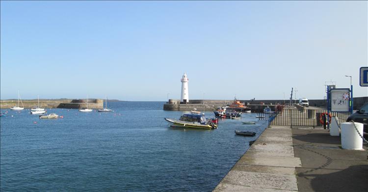 A big harbour and stout wall with a lighthouse at the entrance at Donaghadee
