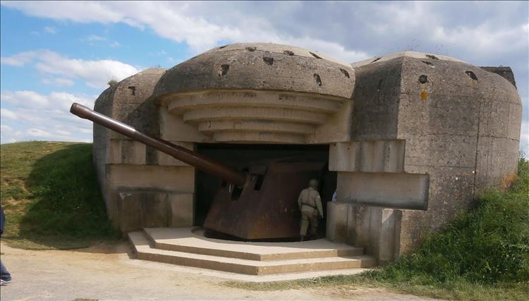 A very large single gun in a study concrete encasement at the battery