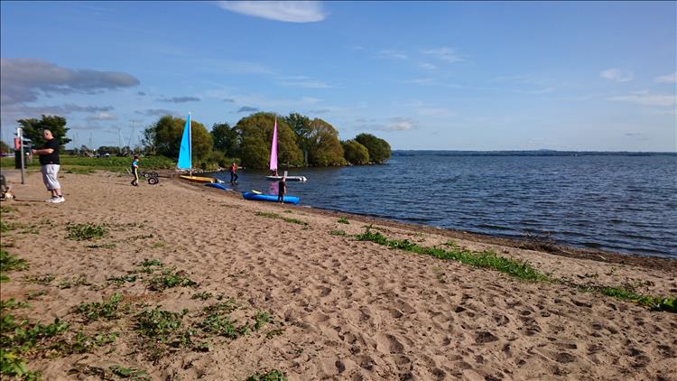 Small sailing dinghies on the shore as kids learn to sail in safety