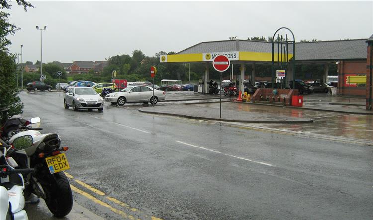 A morrison's petrol station and a motorcycle