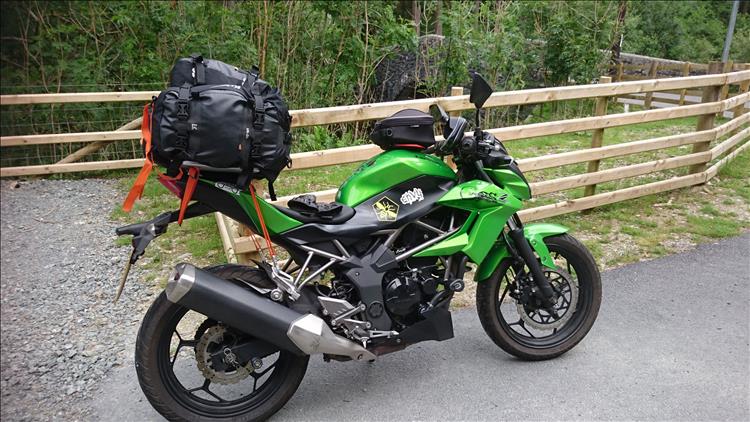 The large luggage load strapped tightly to the Kawasaki