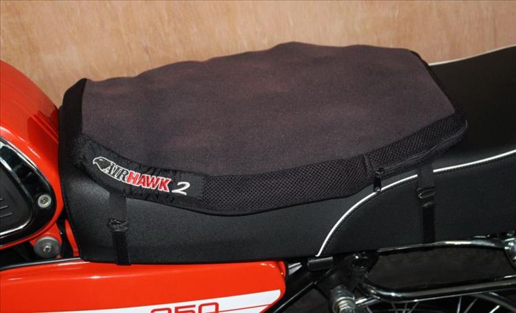 The smart Airhawk pad is strapped to the seat of Mark's Jawa motorcycle