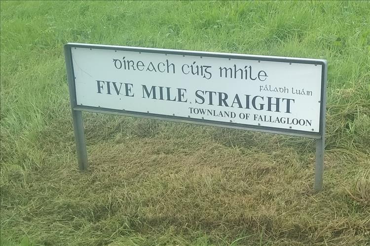 The road sign simply reads five mile straight