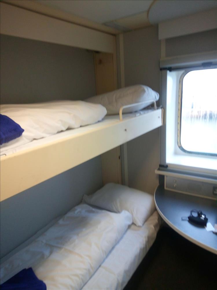 2 bunk beds, a table and a window forms the cabin on the ferry to Fishguard