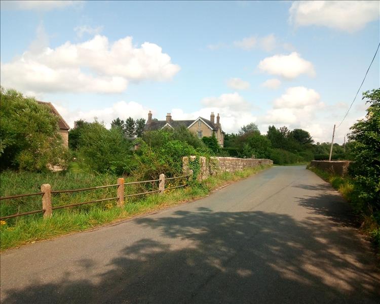 Narrow lanes, trees, hedges, ditches and fields with a couple of old stone built cottages
