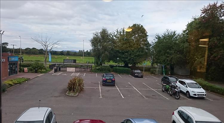 The car park with the motorcycles, as seen from the window of the Travelodge