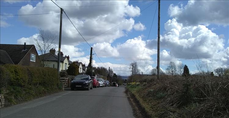 A lane outside Macclesfield with regular but nice houses looking over to the Peak Distric