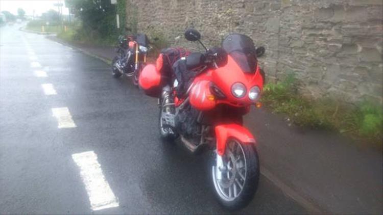 An old style triumph tiger and newer MT09 in the rain