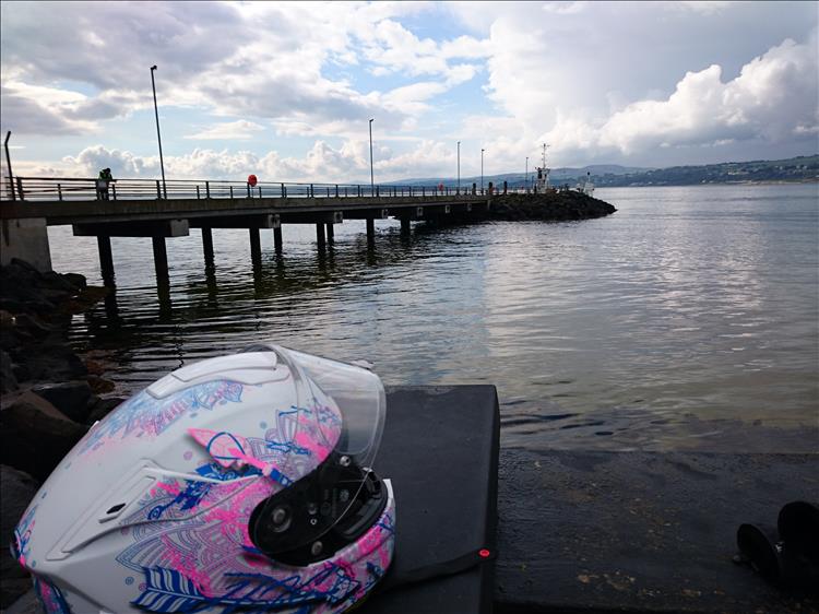 The long jetty to the ferry at Magilligan Point, with Sharon's brightly coloured helmet in the foreground
