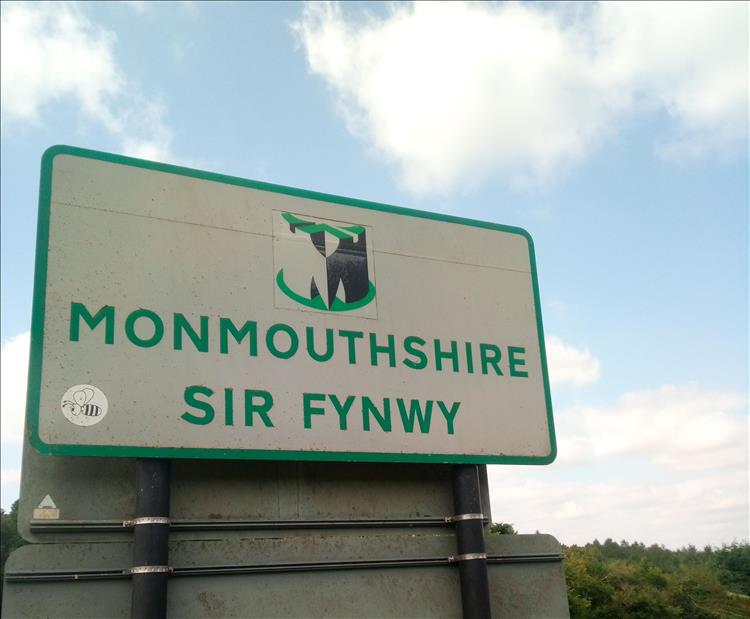The sign simply reads Monmouthshire with the Welsh language Sir Fynwy