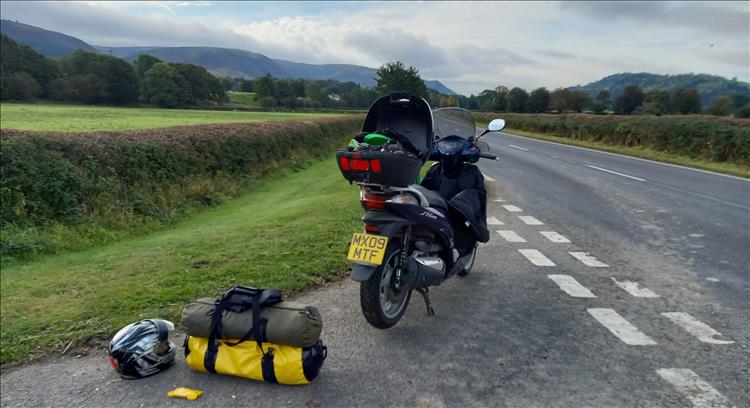 The SH300 and luggage for the weekend in a lovely Welsh setting with hills and fields