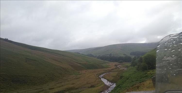 A stream cuts through the wet and misty valley just outside Dunsop Bridge