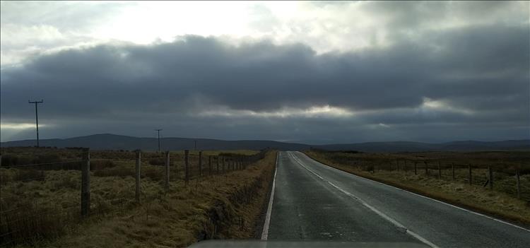 Sunshine and heavy skies over vast Welsh moorland and mountains