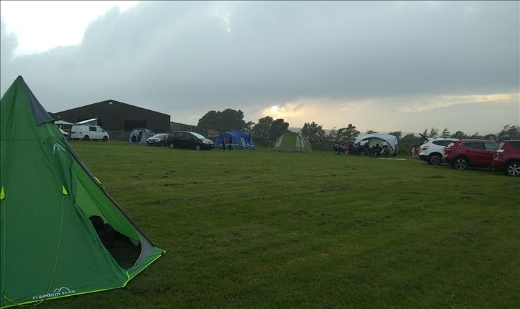 The teepee tent and the other campers in the field at Nun Cote Nook