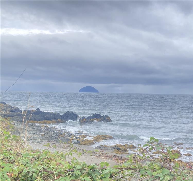 the island is just a half-round protrusion of rock out in the sea under heavy grey skies
