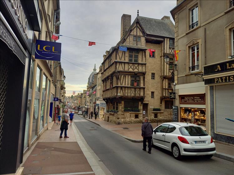 Stone and timber framed buildings with modern shop fronts in Bayeux