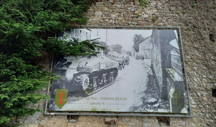 An information board showing a tank rolling into the village from world war 2