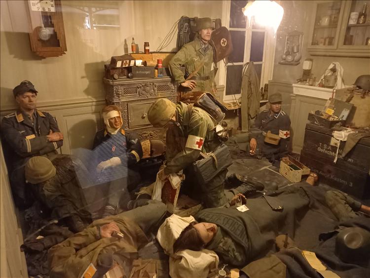 Various dummies in various German uniforms recreating a first aid station in World War 2