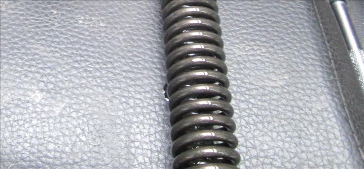 A wound spring from inside of a motorcycle fork leg