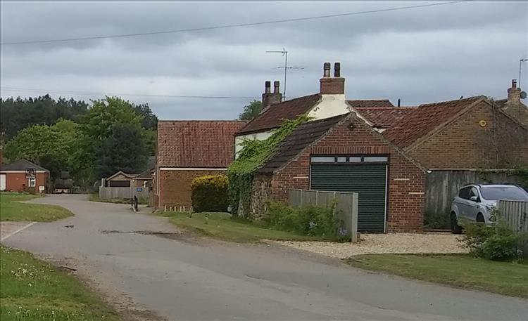 A garage by a quiet peaceful and spacious lane, a few houses here and there