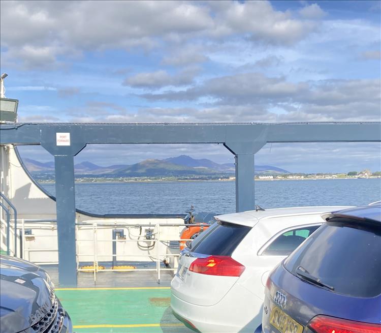 Looking out from the ferry we see mountains and the Lough